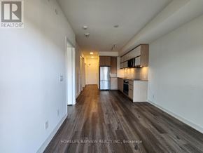 Toronto (Parkwoods-Donalda) condo for rent - A spacious room with wooden flooring and white walls.