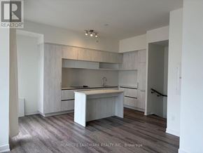 Richmond Hill townhouse for rent - A kitchen with white cabinets and a wooden floor.