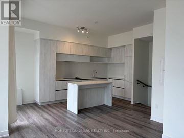 Richmond Hill townhouse for rent - A kitchen with white cabinets and a wooden floor.