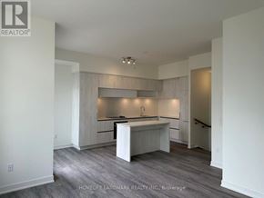 Richmond Hill townhouse for rent - A spacious kitchen with white cabinets and a wooden island.