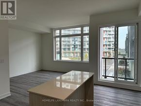 Richmond Hill townhouse for rent - A room with a table and a window overlooking a building.