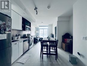 Toronto (York University Heights) condo for rent - A kitchen with a table and chairs in front of a window.