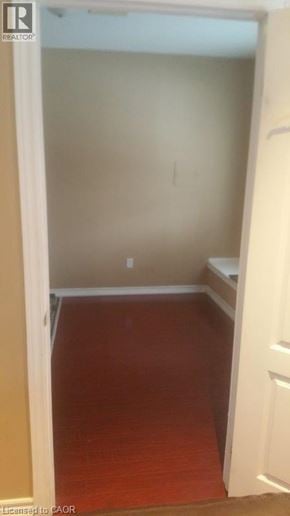Ancaster apartment for rent - A room with a white door and a brown floor.