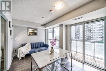 Toronto (Woburn) condo for rent - A living room with a blue couch and a glass table.
