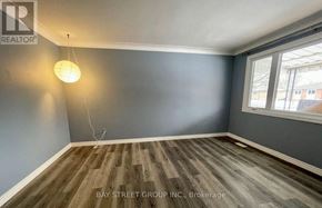 Niagara Falls (Arad/Fallsview) apartment for rent - A room with wooden flooring and a single hanging light fixture.