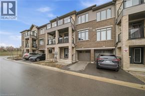 Brantford townhouse for rent - A modern apartment building with a car parked in front.