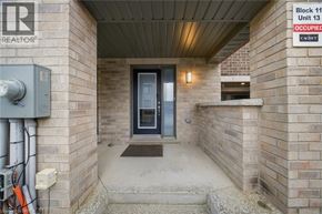 Brantford townhouse for rent - A door is on the left and a sign on the right.