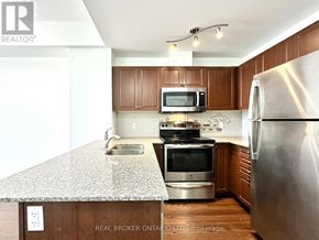 Markham (Old Markham Village) condo for rent - A kitchen with a granite countertop and stainless steel appliances.