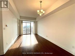 Markham (Old Markham Village) condo for rent - A spacious room with wood flooring and a chandelier.
