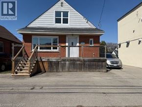 Hamilton apartment for rent - A house with a white door and a porch with a railing.