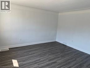 Hamilton apartment for rent - A room with wooden flooring and white walls.