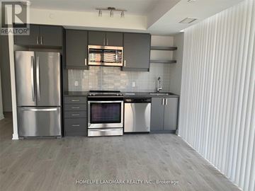 Toronto (Church-Yonge Corridor) condo for rent - A modern kitchen with stainless steel appliances and a wooden floor.