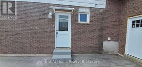 Oakville (Wo West) apartment for rent - A brick house with a white door and a window.