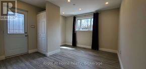 Oakville (Wo West) apartment for rent - A room with a door and a window with black curtains.