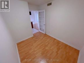 Mississauga (City Centre) condo for rent - A room with wooden flooring and white walls.