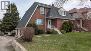 Stoney Creek apartment for rent - A house with a red brick exterior and a grey roof.