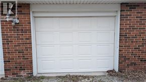 Stoney Creek apartment for rent - A white garage door is closed and has a sign above it that says "REALTOR".
