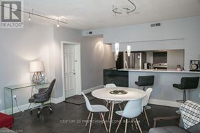 London East (East F) condo for rent - A modern dining room with a glass table and chairs.