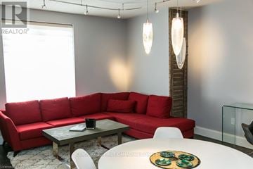 London East (East F) condo for rent - A red couch is in the living room.