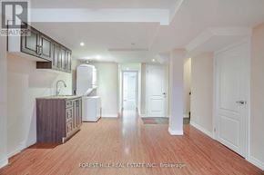 Vaughan (Patterson) apartment for rent - A spacious kitchen with wooden floors and white walls.