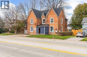 Wallaceburg apartment for rent - A red brick house with a black garage door.