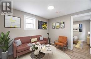 Wallaceburg apartment for rent - A living room with a couch, a chair, a coffee table, and pictures on the wall.