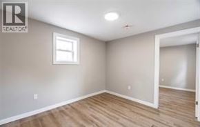 Wallaceburg apartment for rent - A room with a window and wooden floors.