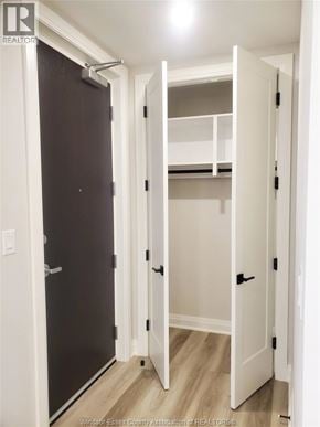 Lasalle condo for rent - A black door is open to a white hallway.