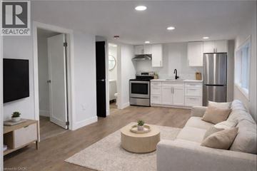 Port Colborne apartment for rent - A modern living room with a grey couch and a coffee table.