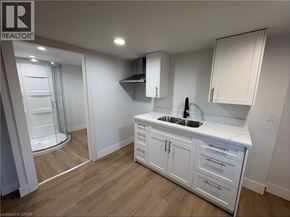 Port Colborne apartment for rent - A white kitchen with a sink and cabinets.