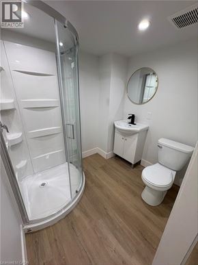 Port Colborne apartment for rent - A white bathroom with a walk in shower and toilet.