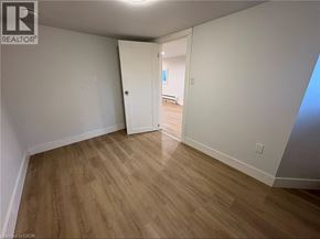Port Colborne apartment for rent - A room with wooden flooring and white walls, with a doorway leading to another room.
