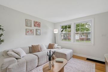 Syracuse apartment for rent - A living room with a grey couch and a coffee table.