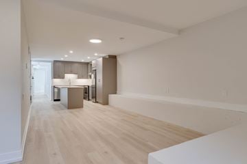 Toronto apartment for rent - A kitchen with a white counter and wooden floors.