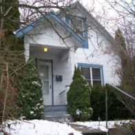 Pullman apartment for rent - A white house with a blue trim and a small porch.