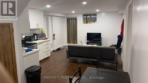 Guelph (Kortright East) apartment for rent - A living room with a black couch and a television.