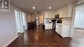 Guelph (Kortright East) apartment for rent - A bathroom with a glass shower door and a brown rug.