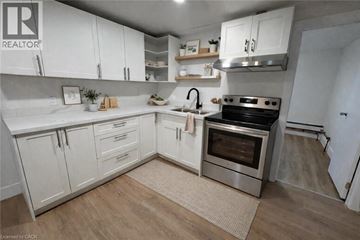 Port Colborne apartment for rent - A kitchen with white cabinets and a stainless steel oven.