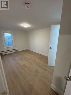 Port Colborne apartment for rent - A room with wooden flooring and a window.