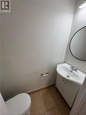 Port Colborne apartment for rent - A white toilet sits next to a sink in a small bathroom.
