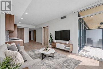 Toronto (Waterfront Communities) condo for rent - A modern living room with a grey sofa and a white coffee table.