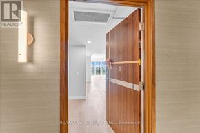 Toronto (Waterfront Communities) condo for rent - A wooden door with a glass window in the middle of a hallway.