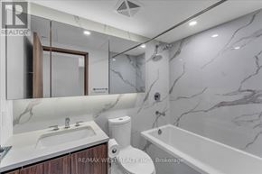 Toronto (Waterfront Communities) condo for rent - A bathroom with marble walls and a bathtub.