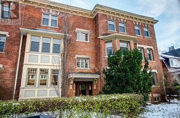 Toronto (Yonge-St. Clair) townhouse for rent - A red brick building with a large front door and windows.