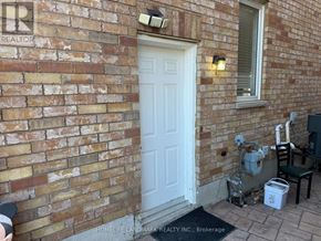 Markham (Greensborough) apartment for rent - A white door is on the left side of a brick wall.
