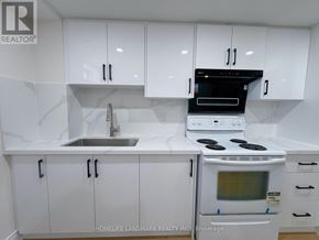Markham (Greensborough) apartment for rent - A white kitchen with a stove, sink, and cabinets.