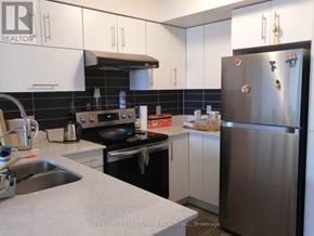 Markham (Commerce Valley) condo for rent - A kitchen with a refrigerator, sink, and stove.