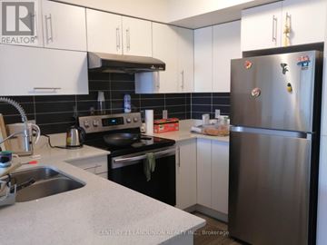 Markham (Commerce Valley) condo for rent - A kitchen with a refrigerator, sink, and stove.