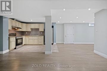 Toronto (Downsview-Roding-Cfb) apartment for rent - A spacious kitchen with beige cabinets and a tiled backsplash.