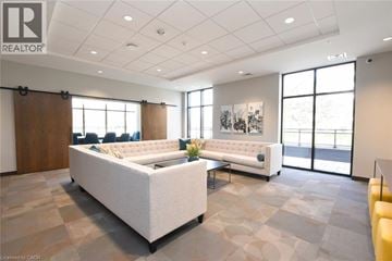 Waterdown condo for rent - A spacious living room with a large couch and a smaller one in the background.